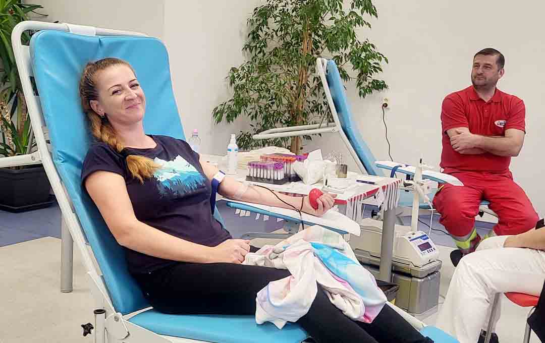 A Bel employee smiling while donating blood.