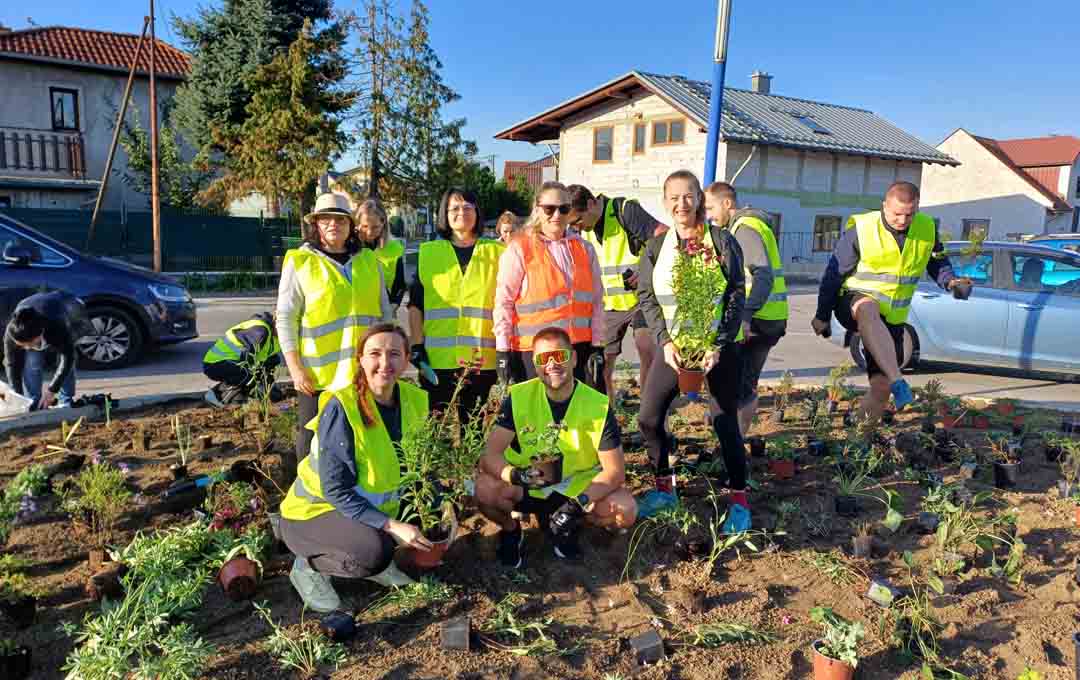 Bel associates outside planting flowers