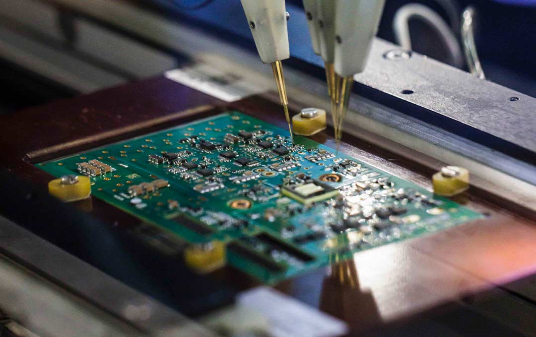 Image of machine at North American factory assembling a pcb board