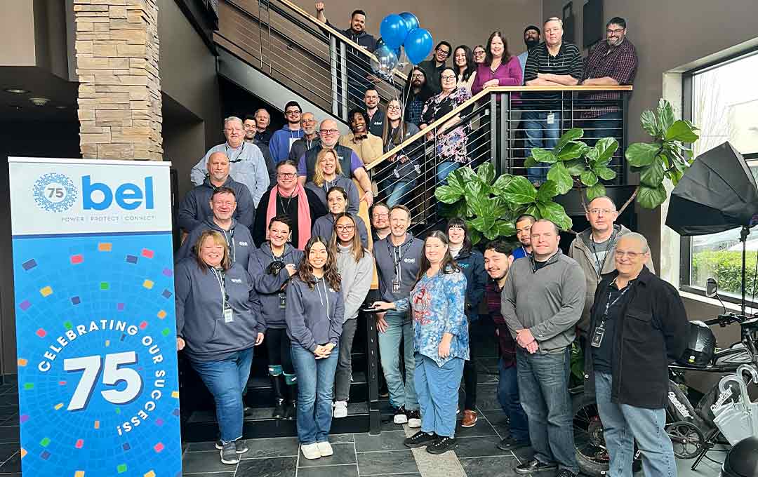 Group photo of North American associates inside office building